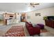 Bright living room with large rug and a view into the kitchen featuring stainless steel appliances at 1799 Jade Ave, Brighton, CO 80603