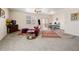 Bright living room with a ceiling fan, carpet flooring, and an adjoining dining area at 1799 Jade Ave, Brighton, CO 80603