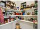 Walk-in pantry featuring ample shelving stocked with a variety of items at 1799 Jade Ave, Brighton, CO 80603