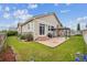 Beautiful backyard featuring a pergola, stone patio, lush lawn, and garden beds at 15524 E 115Th Ave, Commerce City, CO 80022