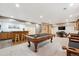 Finished basement boasting a pool table, bar, seating area, and entertainment center at 15524 E 115Th Ave, Commerce City, CO 80022
