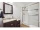 Beautiful bathroom featuring a walk-in shower, stylish vanity, and neutral color palette at 15524 E 115Th Ave, Commerce City, CO 80022