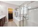 Bright bathroom with a soaking tub, walk-in closet, and dual sinks at 15524 E 115Th Ave, Commerce City, CO 80022