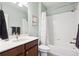 Well-lit bathroom with white tile and a classic vanity with storage at 15524 E 115Th Ave, Commerce City, CO 80022
