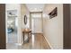 Bright entryway with hardwood floors, coat rack, and views of the bedroom at 15524 E 115Th Ave, Commerce City, CO 80022