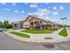 Corner lot home with attractive landscaping, sidewalks, and street sign at 15524 E 115Th Ave, Commerce City, CO 80022