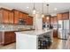 Modern kitchen with a center island, granite countertops, and stainless steel appliances at 15524 E 115Th Ave, Commerce City, CO 80022