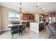 Well-lit kitchen features stainless appliances, granite countertops and a central island at 15524 E 115Th Ave, Commerce City, CO 80022