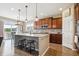 Well-lit kitchen with island seating, stainless steel appliances, and hardwood floors at 15524 E 115Th Ave, Commerce City, CO 80022