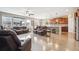 Bright open-concept living room and kitchen featuring hardwood flooring at 15524 E 115Th Ave, Commerce City, CO 80022