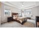 Bright and airy bedroom boasts plush carpeting and a tray ceiling at 15524 E 115Th Ave, Commerce City, CO 80022