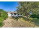 Backyard featuring a lush green lawn and mature trees at 1926 S Yates St, Denver, CO 80219