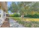 Backyard with a beautiful big tree and pathway at 1926 S Yates St, Denver, CO 80219