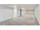 Spacious basement area with neutral carpeting, recessed lighting, and white painted walls at 1926 S Yates St, Denver, CO 80219