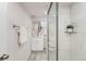 Basement bathroom featuring a glass door shower, updated fixtures, and modern design elements at 1926 S Yates St, Denver, CO 80219