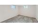Finished basement bedroom with neutral carpet, white walls, and natural light from egress windows at 1926 S Yates St, Denver, CO 80219