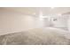 Large finished basement features recessed lighting and neutral carpeting at 1926 S Yates St, Denver, CO 80219