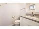 Clean half bath features a modern vanity, stone counter and fixtures at 1926 S Yates St, Denver, CO 80219