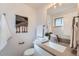 Modern bathroom featuring a sleek vanity, neutral color palette, and decorative wall art at 1926 S Yates St, Denver, CO 80219