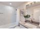 Stylish bathroom with a tiled shower, framed mirror, and elegant vanity with modern fixtures at 1926 S Yates St, Denver, CO 80219