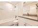 Modern bathroom features a white tile shower, vanity, and updated fixtures at 1926 S Yates St, Denver, CO 80219
