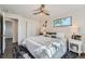 Comfortable bedroom featuring a ceiling fan, plush rug, and ample natural light at 1926 S Yates St, Denver, CO 80219