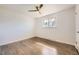 Bright bedroom with wood-look floors, a ceiling fan and natural light at 1926 S Yates St, Denver, CO 80219