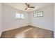 Comfortable bedroom features a ceiling fan, natural light and hard wood flooring at 1926 S Yates St, Denver, CO 80219