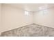 Bright bedroom features neutral walls, carpeting, and two windows offering natural light at 1926 S Yates St, Denver, CO 80219
