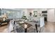 Open dining area with modern furniture, seamlessly connected to the kitchen and living spaces at 1926 S Yates St, Denver, CO 80219