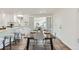 Dining area with a modern table setting, stylish seating, and seamless access to the kitchen at 1926 S Yates St, Denver, CO 80219