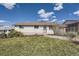 Charming single-story home with a well-maintained lawn, white brick and sunny skies at 1926 S Yates St, Denver, CO 80219