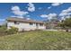 Charming single-story home with a well-maintained lawn, white brick and sunny skies at 1926 S Yates St, Denver, CO 80219