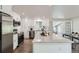 Bright kitchen featuring stainless steel appliances, white cabinets, and a large center island at 1926 S Yates St, Denver, CO 80219