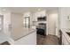 Modern kitchen boasts white cabinetry, stainless steel appliances, an island and hardwood floors at 1926 S Yates St, Denver, CO 80219