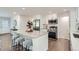 Modern kitchen with stainless steel appliances, a spacious island, and sleek white cabinetry at 1926 S Yates St, Denver, CO 80219