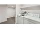 Functional laundry room featuring a washer, dryer, and storage shelving at 1926 S Yates St, Denver, CO 80219