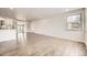 Bright living room featuring hardwood floors and a large window with lots of natural light at 1926 S Yates St, Denver, CO 80219