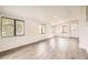 Bright sun room featuring hardwood floors, white walls and modern trim at 1926 S Yates St, Denver, CO 80219