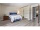 Spacious bedroom with a large closet, light wood floors, and a comfortable bed at 13977 E Bails Pl, Aurora, CO 80012