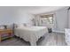 Comfortable bedroom with a bright window, light gray walls, and light wood floors at 13977 E Bails Pl, Aurora, CO 80012