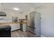 Well-lit kitchen with stainless steel refrigerator, wood countertops and white cabinets at 13977 E Bails Pl, Aurora, CO 80012