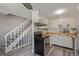 Functional kitchen featuring stainless steel oven, butcher block counters, and a nearby staircase at 13977 E Bails Pl, Aurora, CO 80012