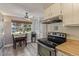 Bright kitchen area with a dining nook, stainless steel appliances, and painted cabinets at 13977 E Bails Pl, Aurora, CO 80012