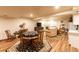 Open-concept basement featuring a dining area, living space with a fireplace, and kitchenette offering flexible living at 3 Pinyon Pine Rd, Littleton, CO 80127