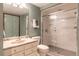 Bathroom featuring a glass-enclosed shower, vanity with sink and toilet at 3 Pinyon Pine Rd, Littleton, CO 80127