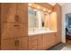 A well-lit double vanity featuring wooden cabinetry that gives plenty of storage space in this large, bright bathroom at 3 Pinyon Pine Rd, Littleton, CO 80127