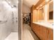 Bathroom featuring a glass shower, double vanities, and a walk-in closet, for the ultimate in style and functionality at 3 Pinyon Pine Rd, Littleton, CO 80127