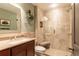 Bathroom with a glass-enclosed shower, dark-wood vanity and a warm neutral color scheme at 3 Pinyon Pine Rd, Littleton, CO 80127