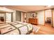 Bedroom featuring wood floors, an area rug and a wooden dresser with decorative mirror at 3 Pinyon Pine Rd, Littleton, CO 80127